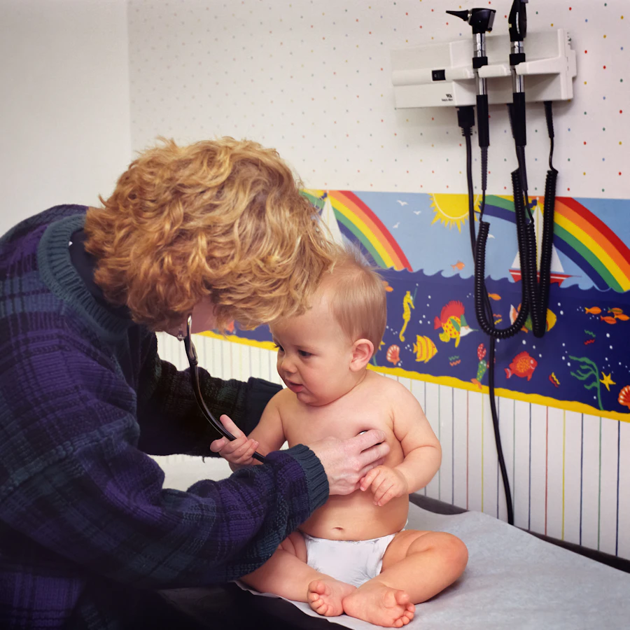 Pediatrician examining a young child with a stethoscope
